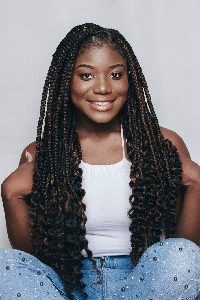 Portrait of a Smiling Woman with Black Hair in Dreadlocks